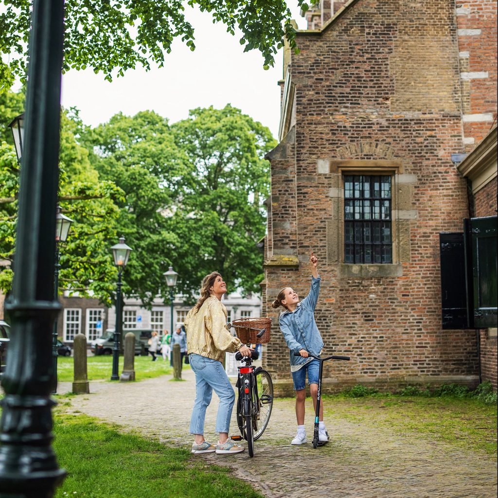 Grote Kerk tower Grotekerkstuin children bicycle walking summer Dordrecht
